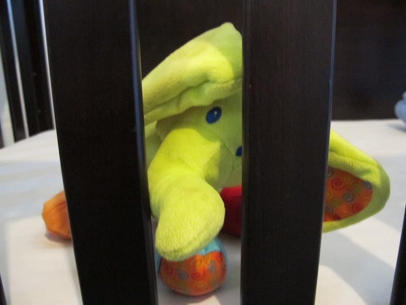 Yellow toy elephant in a child's crib