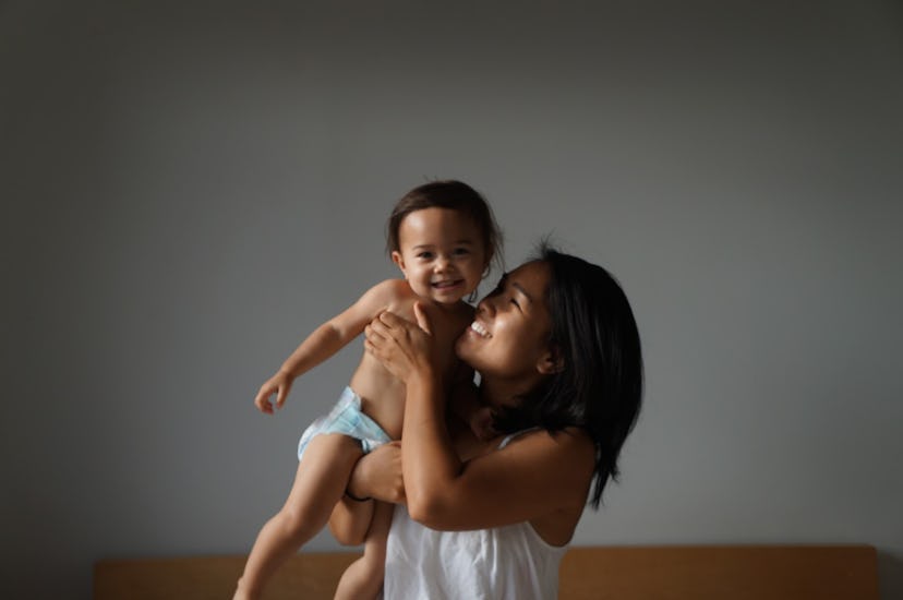 Loreann Talbo holding her toddler and smiling 