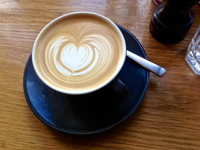 A cup of latte with a heart-shaped coffee art