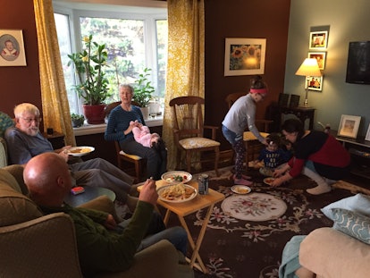 People sitting in a living room during a Thanksgiving gathering