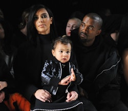 Kim and Kanye sitting with their North West baby