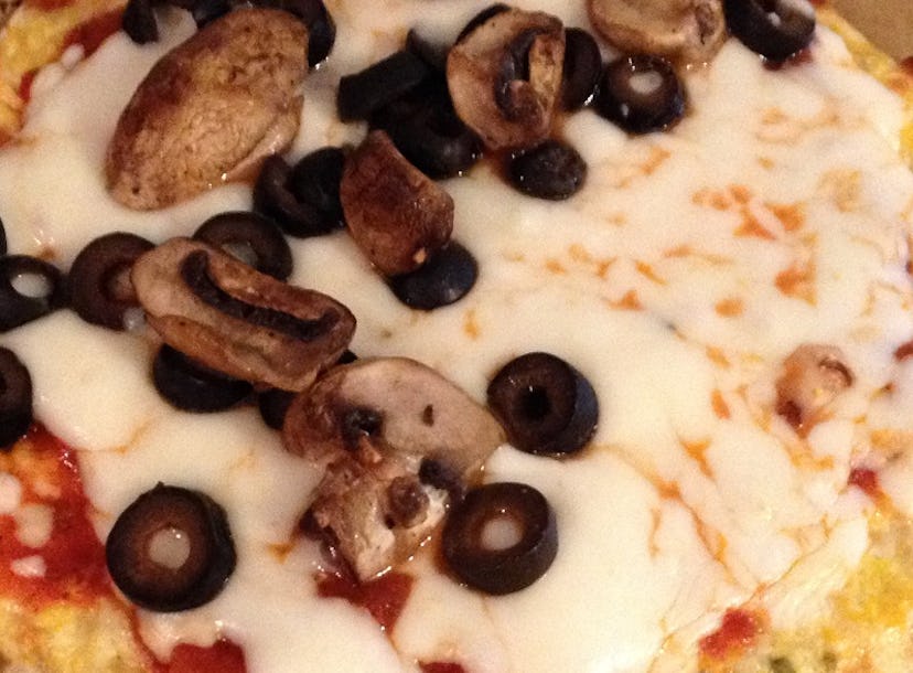 Cauliflower pizza with cheese, olives and mushrooms