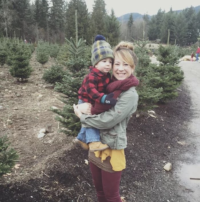 A woman, who breastfed in public without covering up, holding her kid in winter clothing
