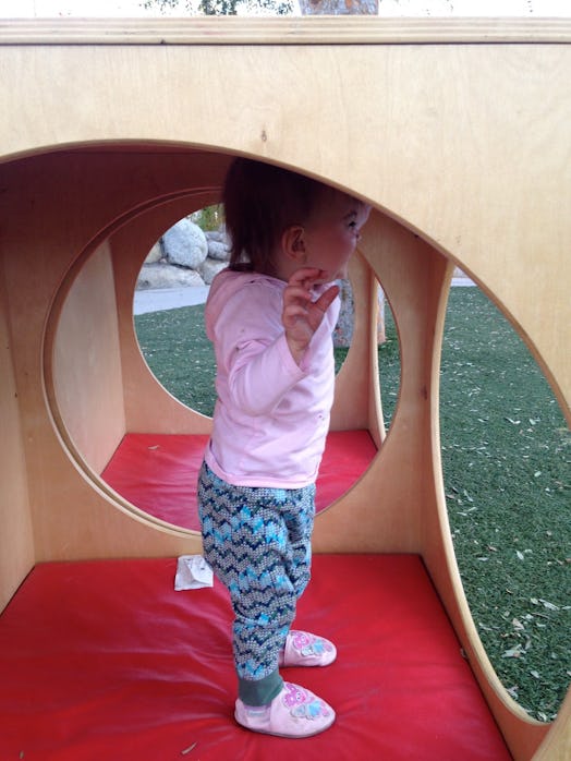 A toddler girl playing in the park 