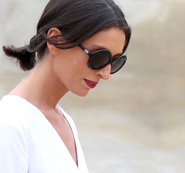 A woman with low ponytail and sunglasses
