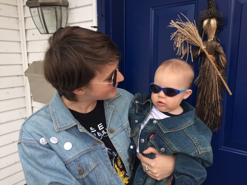  A mom and her toddler both wearing thrifted denim jackets and sunglasses.