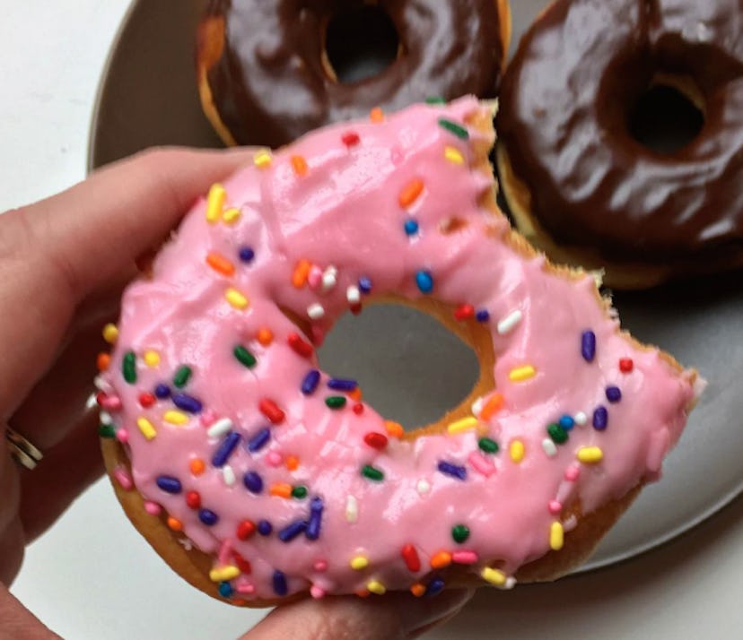 Image of a doughnut with pink glaze and colorful sprinkles