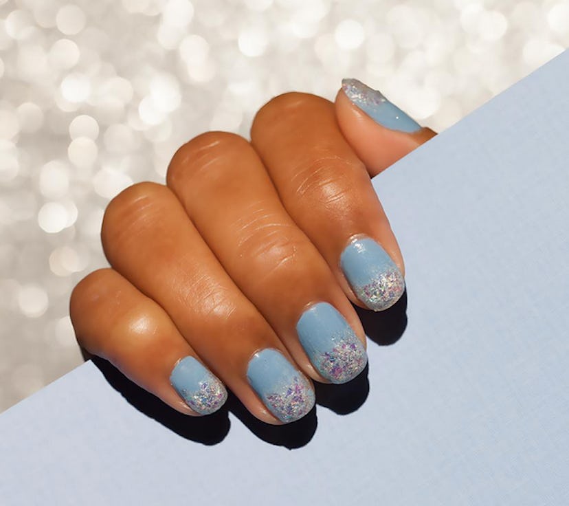 Image of blue nail polish on a girl's hand