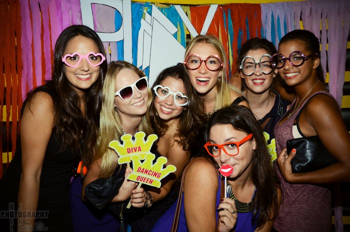 Seven ladies posing for a photo at a New Year’s Eve party