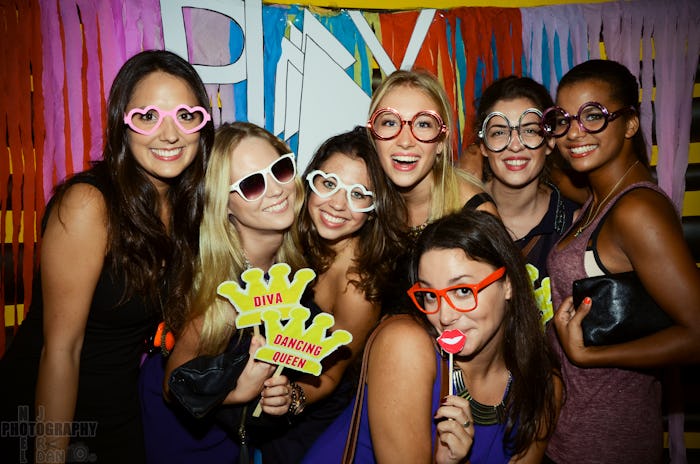 Seven ladies posing for a photo at a New Year’s Eve party