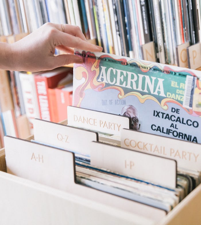 A hand grabbing a record package