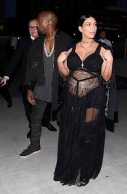 Pregnant Kim Kardashian walking in a black dress