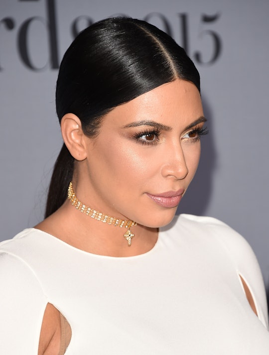 Kim Kardashian wearing a white evening dress to a red carpet event