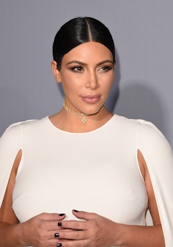 Kim Kardashian giving an interview in a white dress