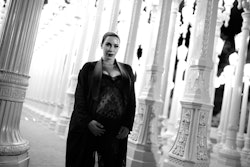 A black and white photo of pregnant Kim Kardashian holding her belly in Givenchy at the LACMA 2015 A...