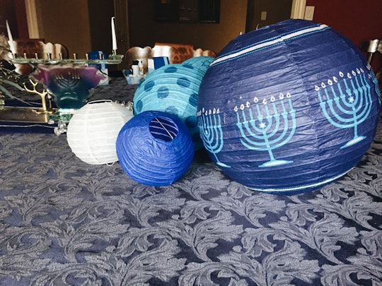 Blue paper lanterns with an illustrated Hanukkah candles on them