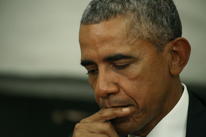 A former president Barack Obama nervously looking down.