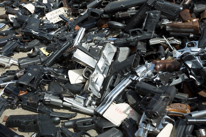 a lot of guns in a pile