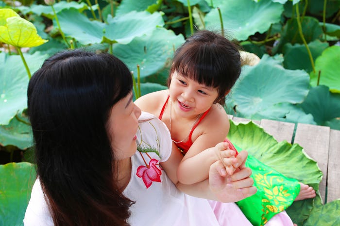Woman playing with her daughter outside