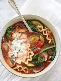 Vegetarian lasagna soup served in a bowl with a spoon