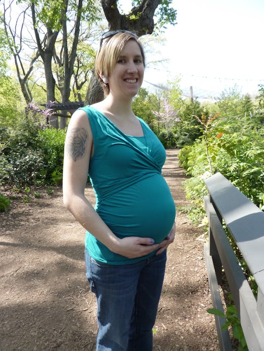 Skinny-shamed pregnant woman posing in a blue blouse