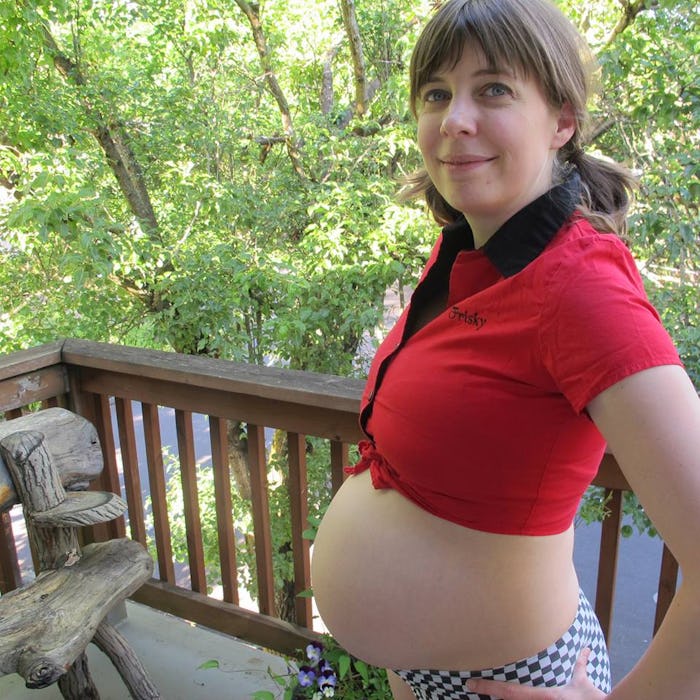 A woman proudly showing off her pregnancy belly and her stretch marks that she loves