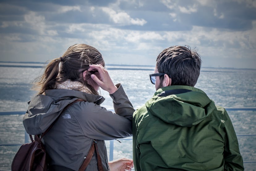 A couple sitting on the seaside and talking