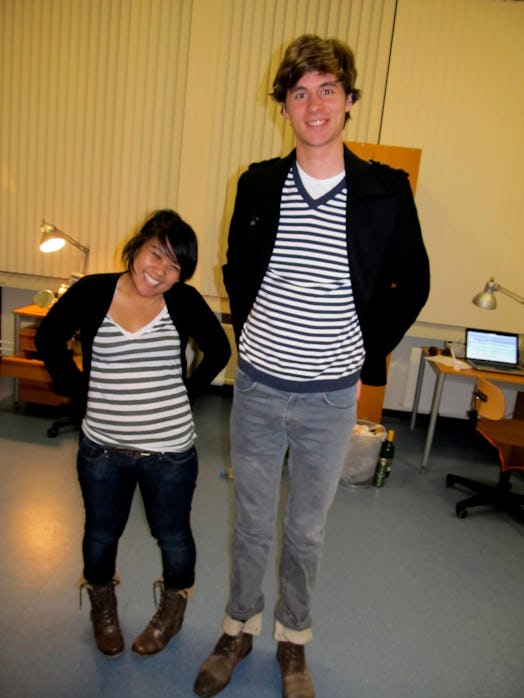 The author is standing next to a man, both wearing t-shirts with black and white stripes