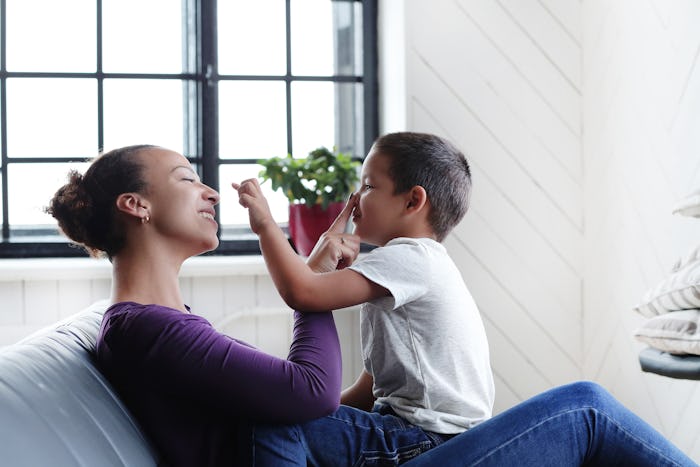 A mom who want to build an honest relationship with her child, playing with the kid on a couch