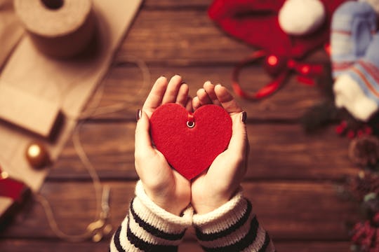 A woman holding a red heart-shaped Valentine's gift box