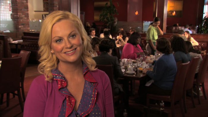Amy Poehler as Leslie Knope standing in a bar on galentine's day