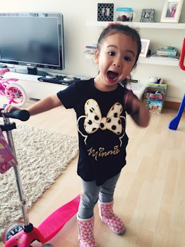 A girl wearing a 'Minnie Mouse' t-shirt with her mouth opened