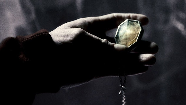 Slytherin's locket jewelry held by a hand