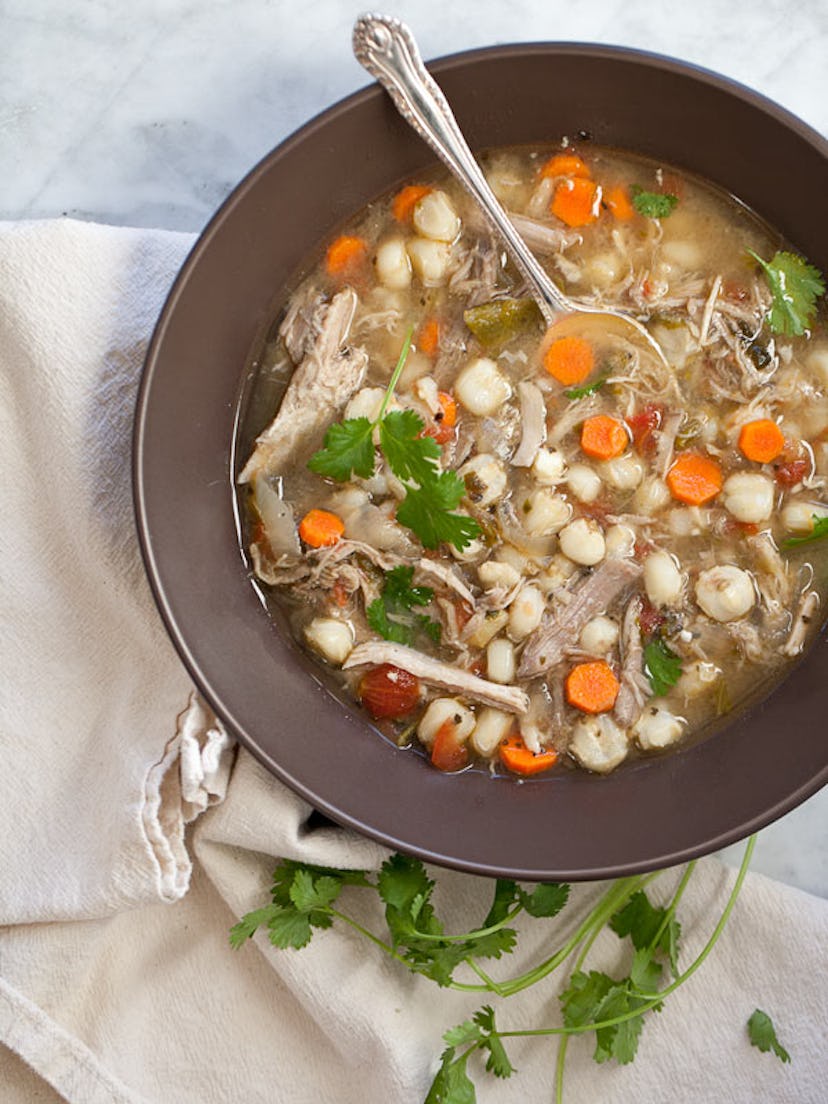 A grey bowl full of Pork Posole Stew