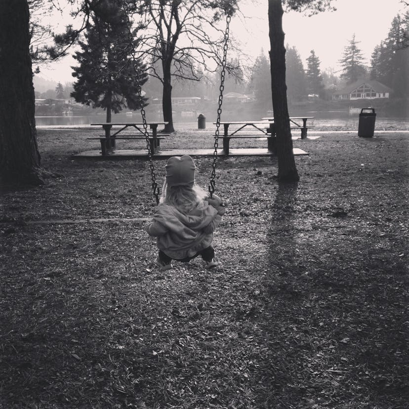 Toni Hammers' daughter swinging on a swing in the park