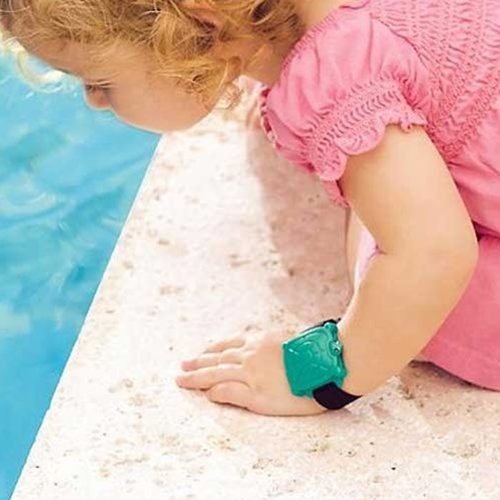 A little girl leaning towards a pool wearing the Safety Turtle Swimming Pool Alarm