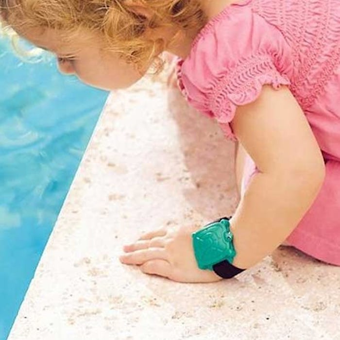 A little girl leaning towards a pool wearing the Safety Turtle Swimming Pool Alarm