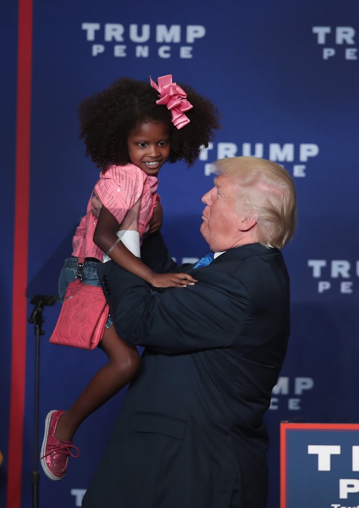 Donald Trump holding a little girl