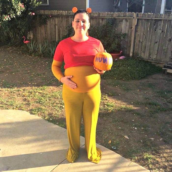 A pregnant woman dressed as Winnie the Pooh for Halloween.