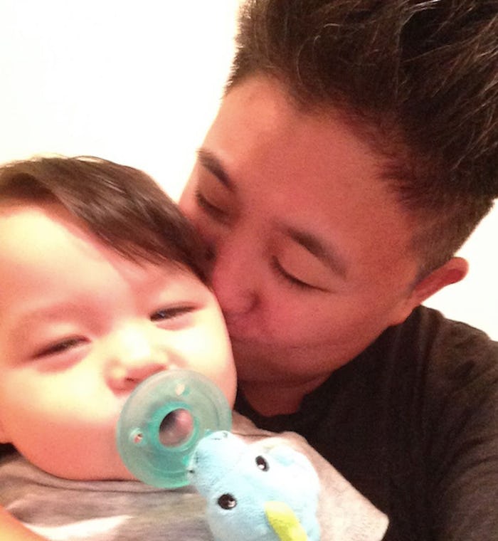 Lacey Vorrasi-Banis kissing her toddler with a pacifier