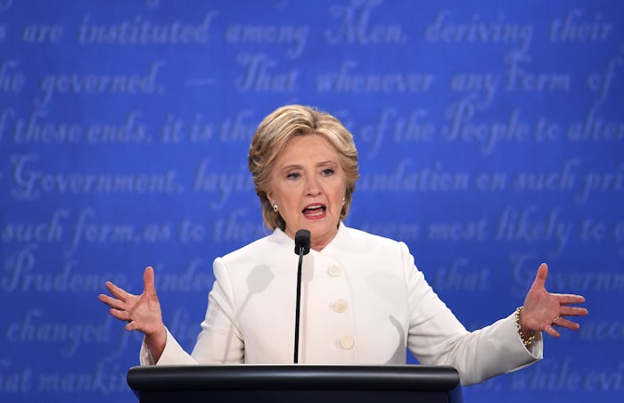 Hillary Clinton in a white blazer giving a speech