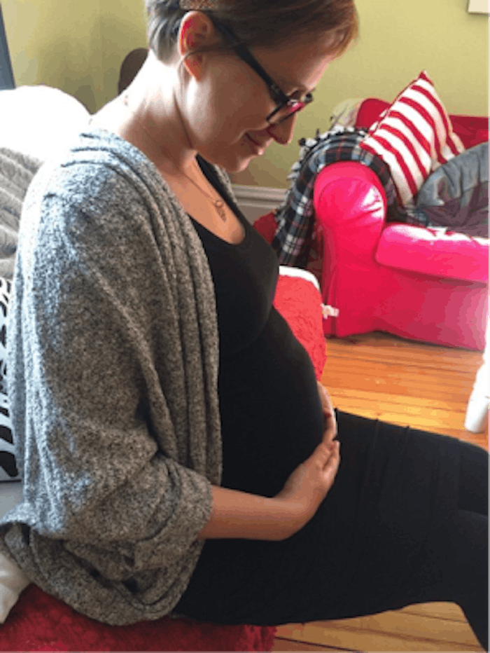 Ceilidhe Wynn holds her pregnant stomach while experiencing Amniocentesis