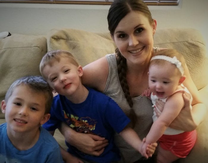 Stay-at-home mother posing with her three kids on a couch