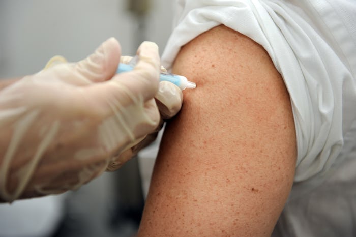 A person getting free flu vaccine in their arm