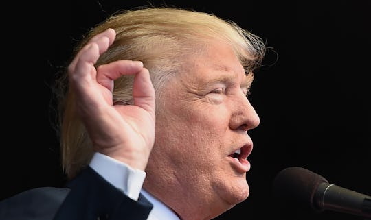 Donald Trump talking in front of a microphone