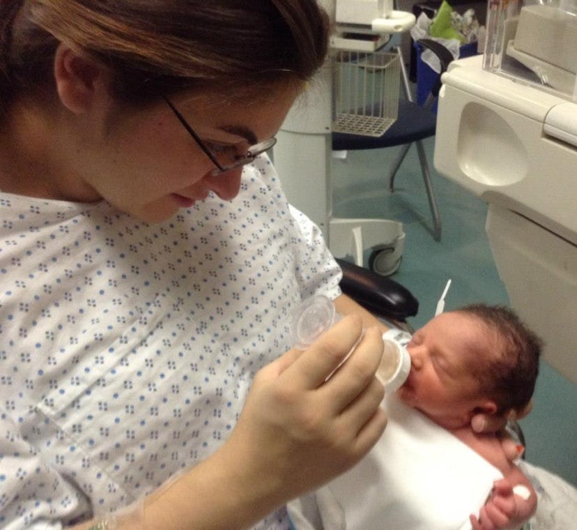 Photo of Megan Zander while feeding her newborn