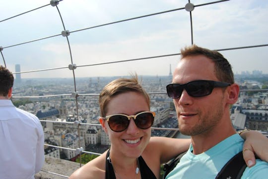 A couple standing at the empire state building on a sunny day