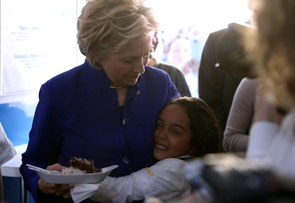 Hillary Clinton hugged by a little girl