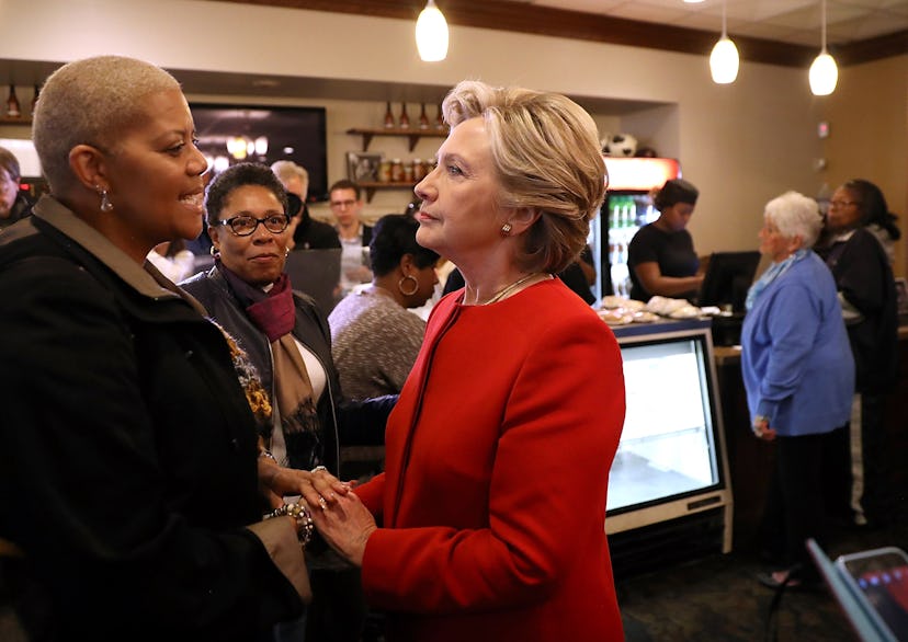 Hillary Clinton shaking hands in a red blazer