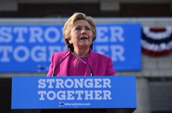 Hillary Clinton giving a speech in a pink suit 